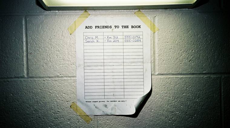 A sheet of paper taped to a cinder-block wall under a fluorescent light. The printed heading reads ADD FRIENDS TO THE BOOK, above a ruled table with two lines filled in by hand and the rest empty.